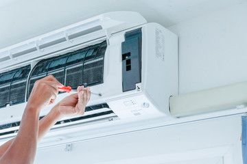 壁掛けエアコンを整備する手元